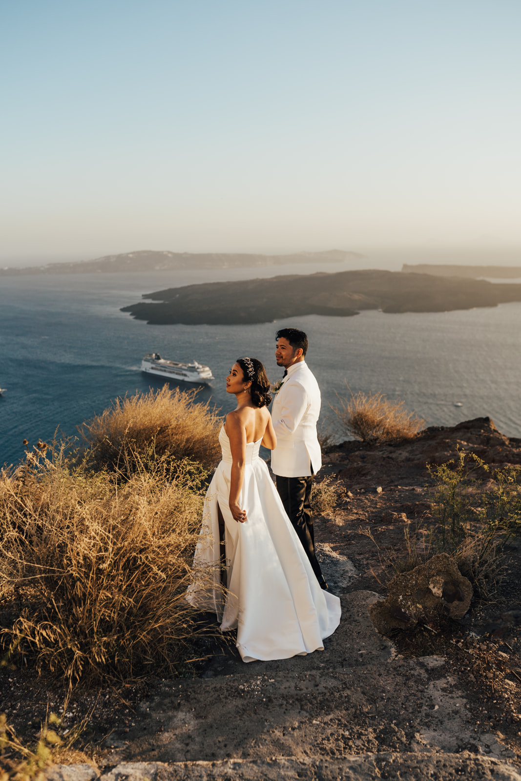 bride and groom in Santorini walking up mountain