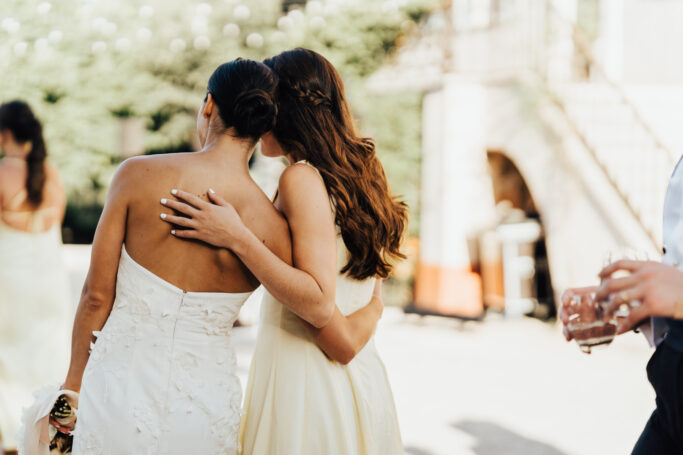bride and bridesmaid hugging