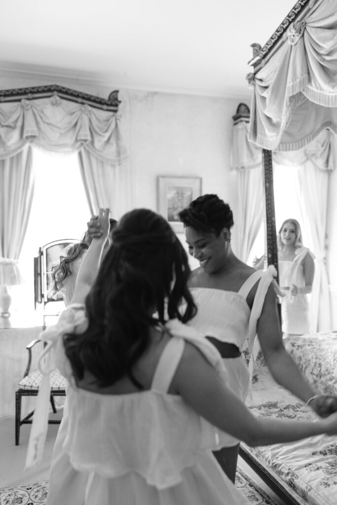 bridesmaids lying on the bed getting ready wearing white pjs