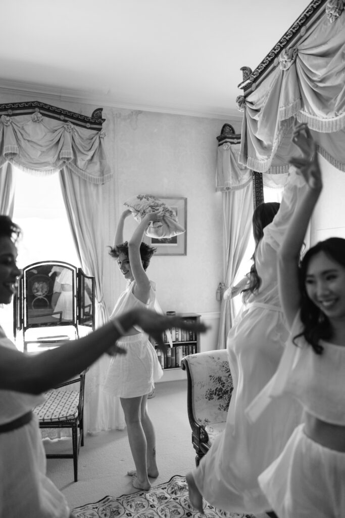 bridesmaids lying on the bed getting ready wearing white pjs