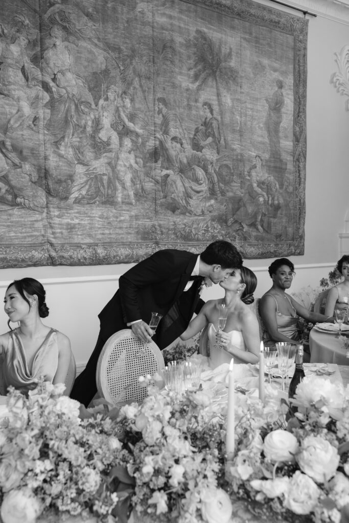 photo of groom giving speech and kissing bride