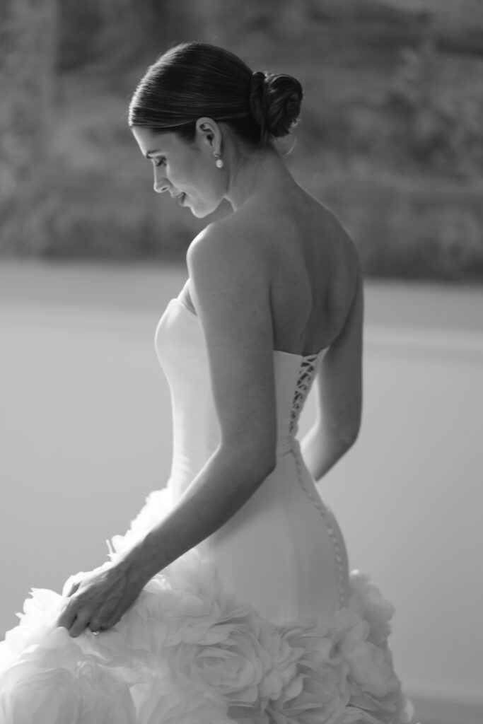 bride standing infront of tapestry