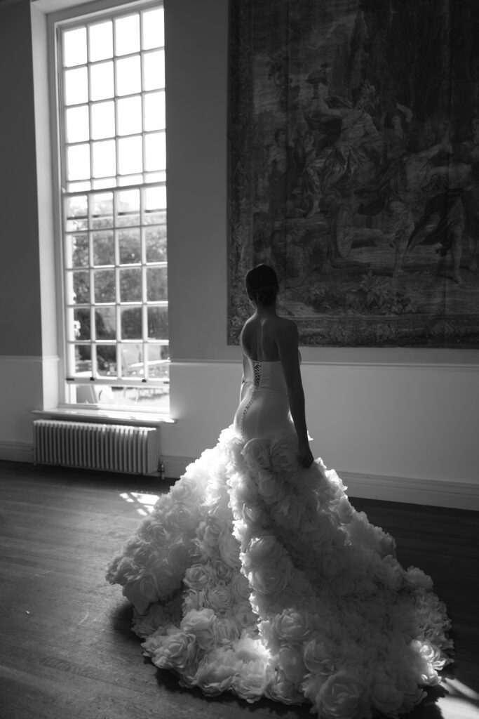 bride standing infront of tapestry and twirling