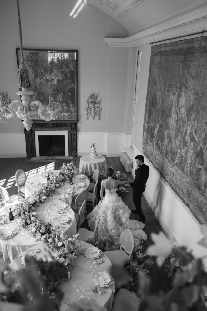 bride and groom walking past tables on wedding