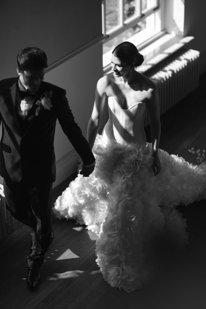 bride and groom walking past tables on wedding