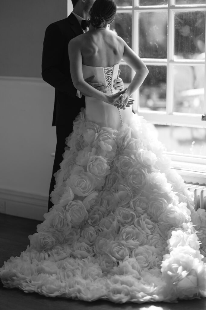 bride and groom walking past tables on wedding