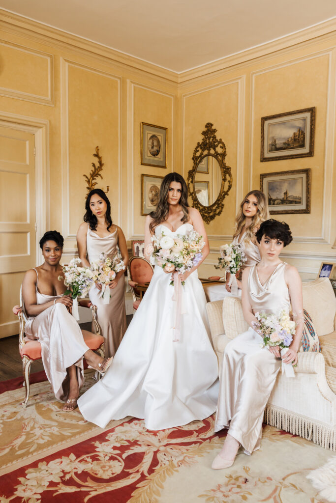 bride and bridesmaids in cornwell manor room holding bouquets