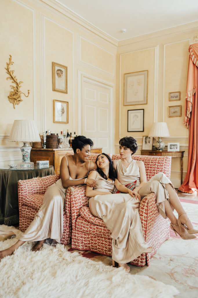 three bridesmaids lying on couch