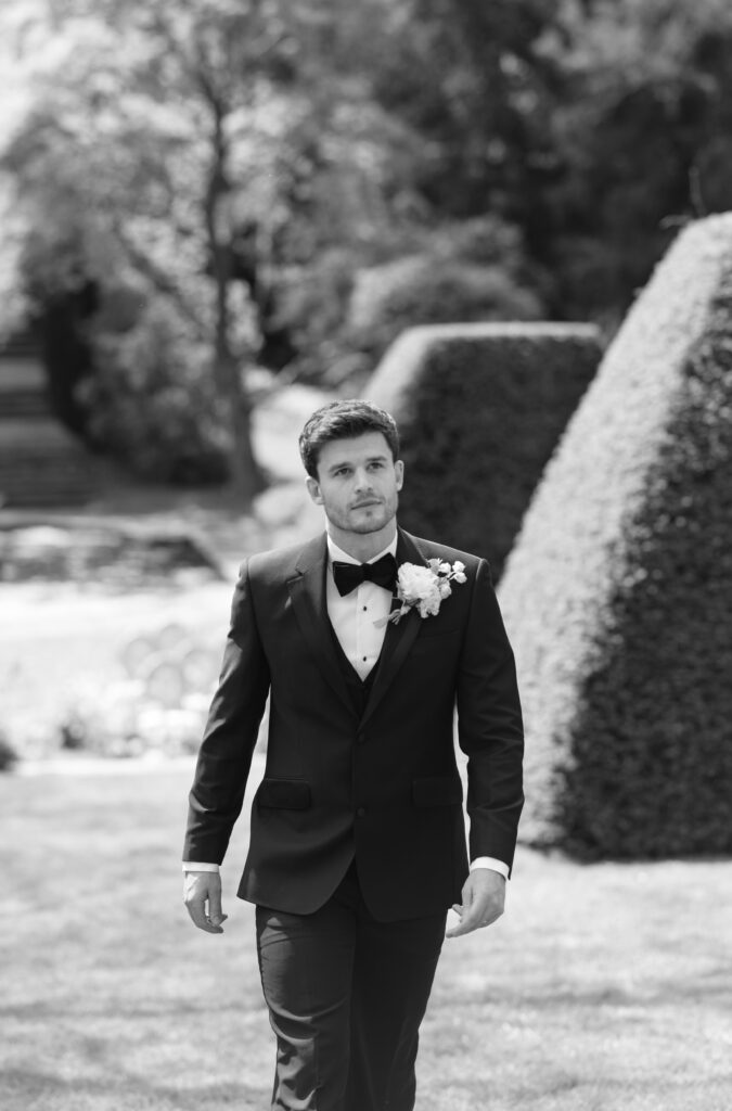 Groom walking black and white photo