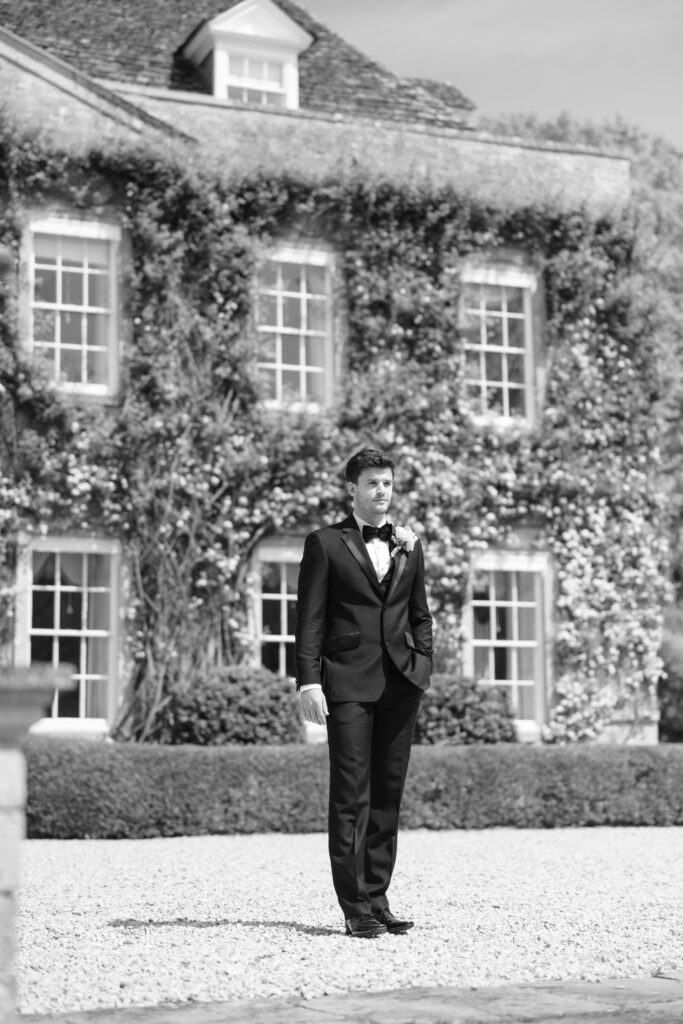 black and white photo of groom outside