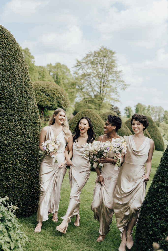 bridesmaids walking holding hands