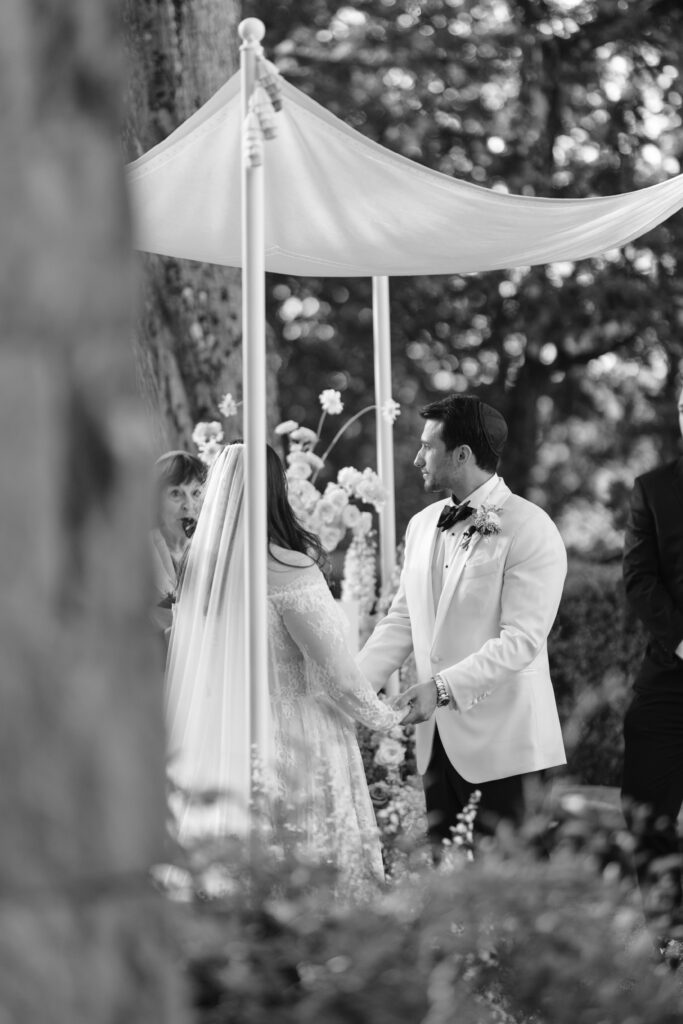 bride and groom under chuppah