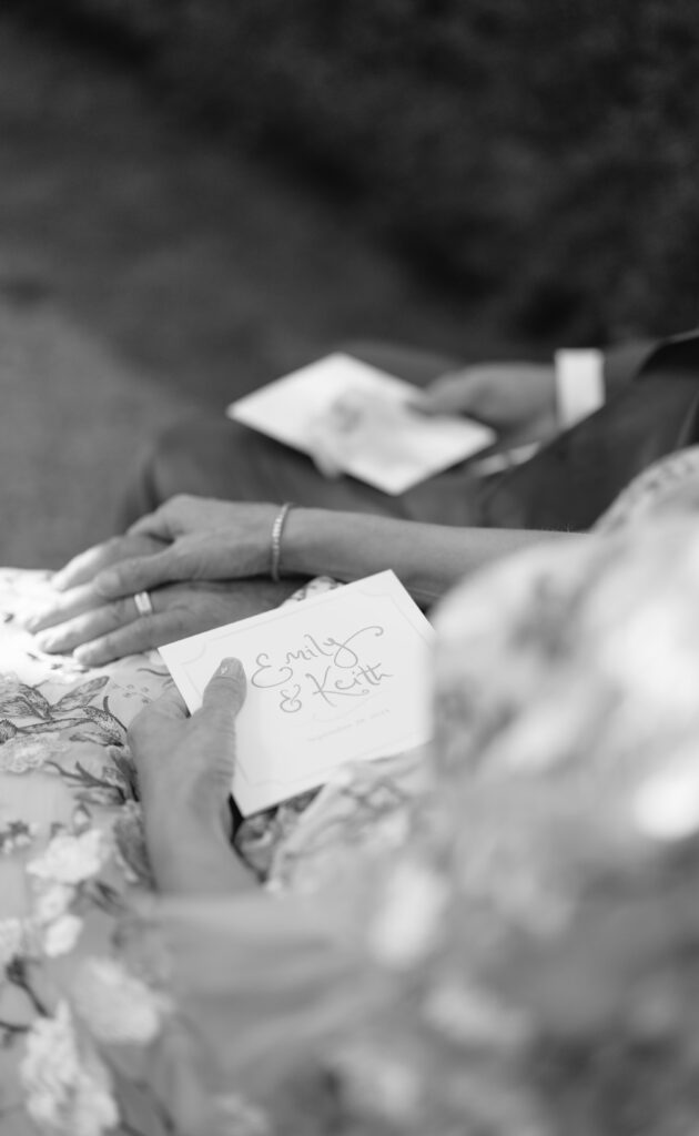 photo of mother of bride and father holding hands