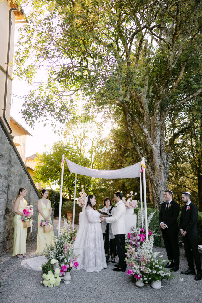 bride and groom at alter under the chuppah