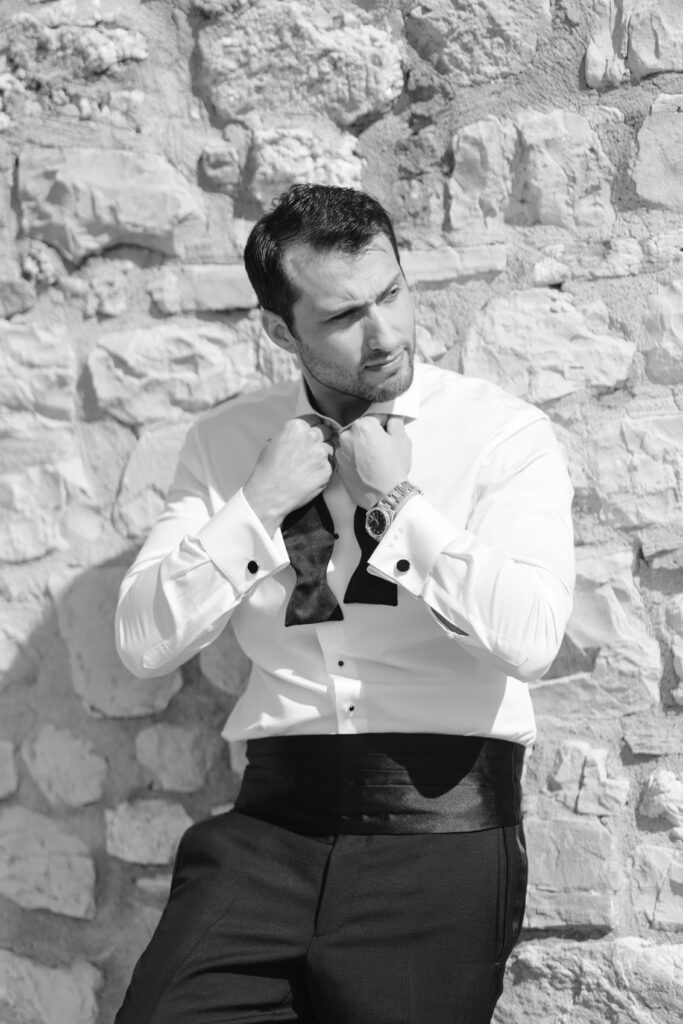 groom adjusting bow tie