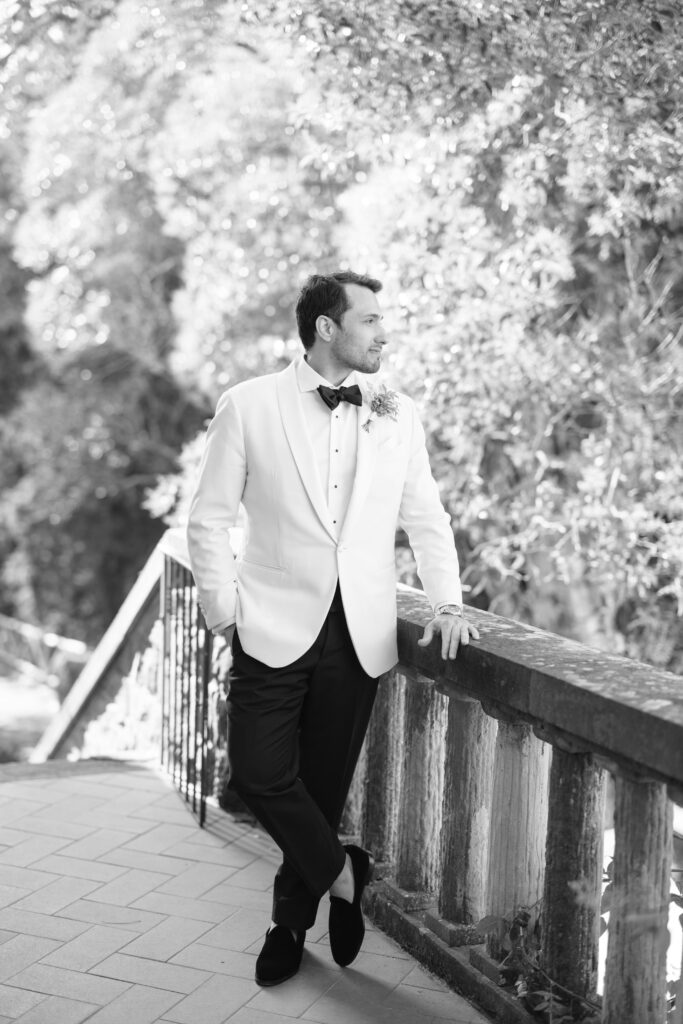 groom in white tuxedo