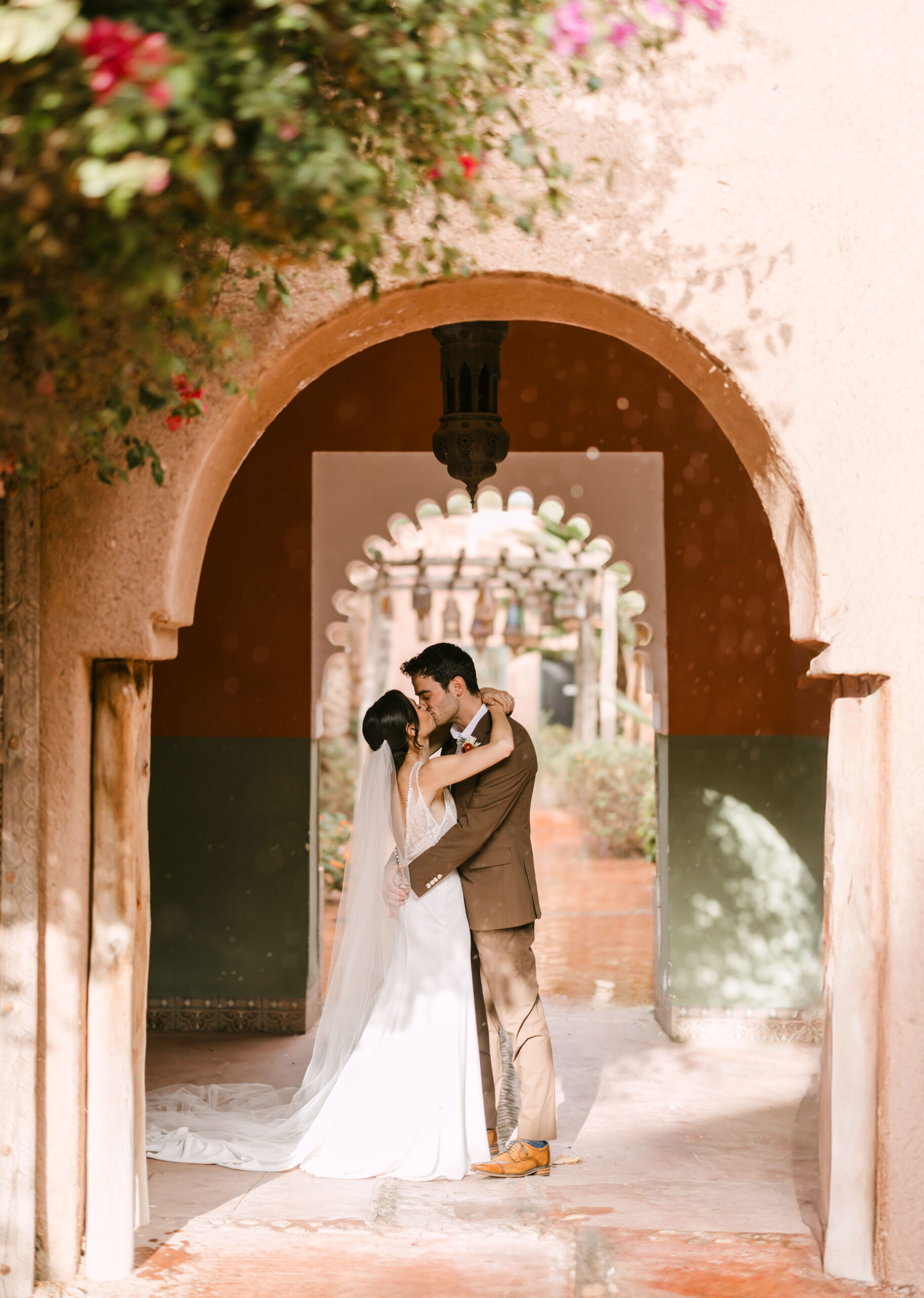 Bride and groom under moroccan arch