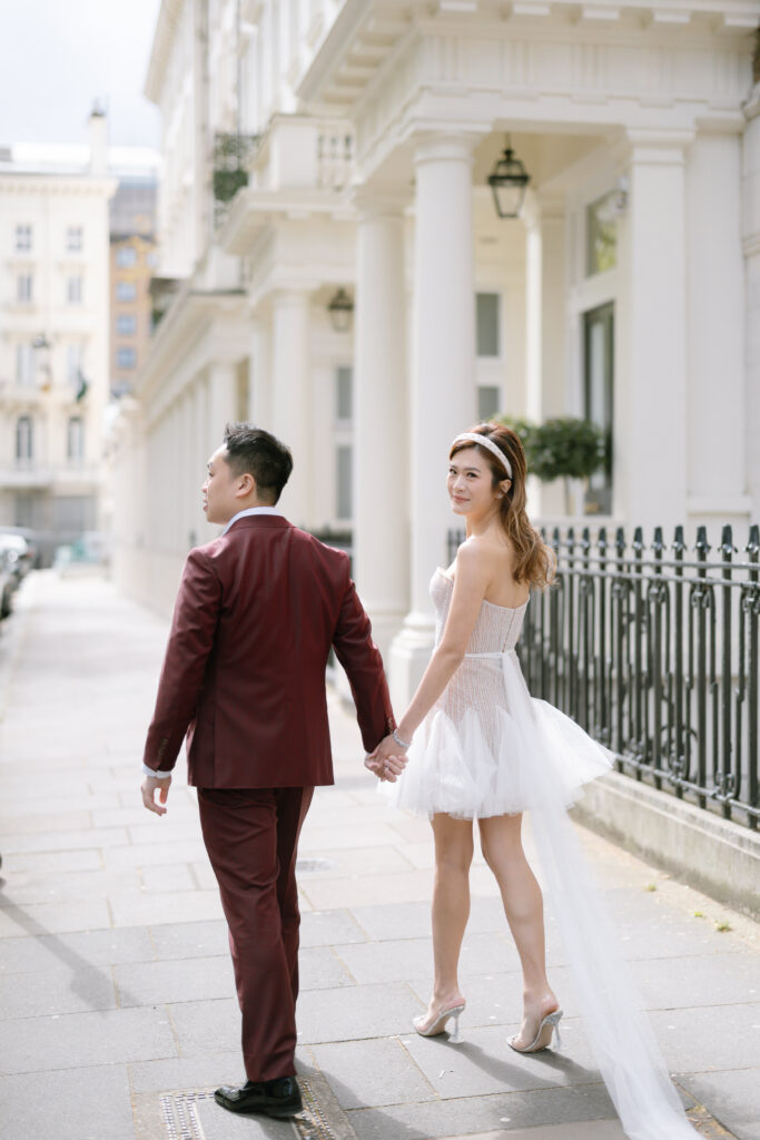 bride and groom holding hands walking