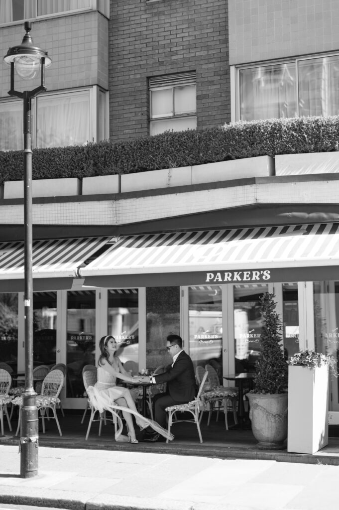 bride and groom sat outside cafe in London