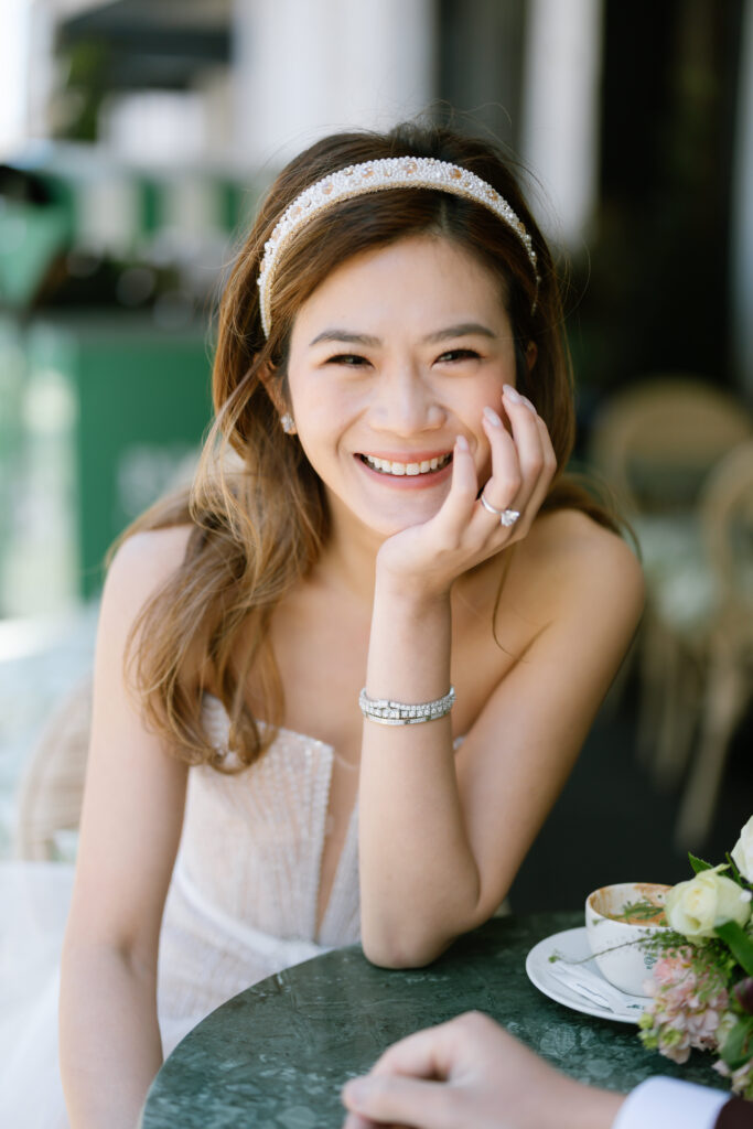 photo of girl resting on table wearing liz Martinez bridal mini dress