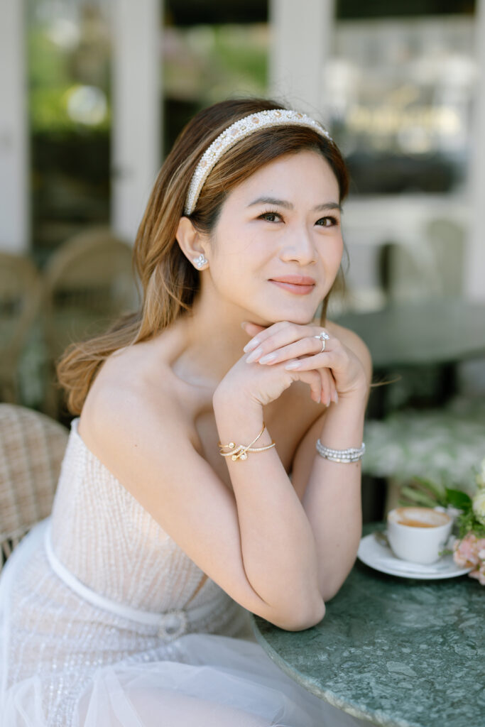 photo of girl resting on table wearing liz Martinez bridal mini dress