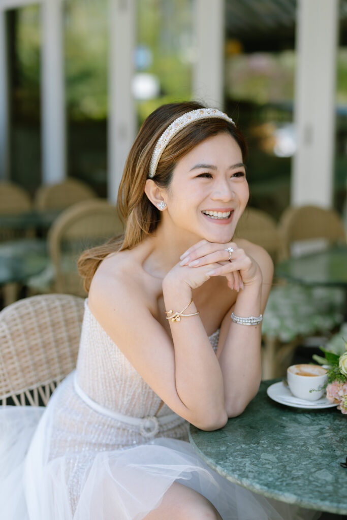 photo of girl resting on table wearing liz Martinez bridal mini dress