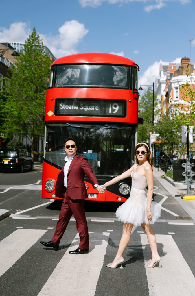 london pre wedding shoot bride and groom walking holding hands infront of london bus