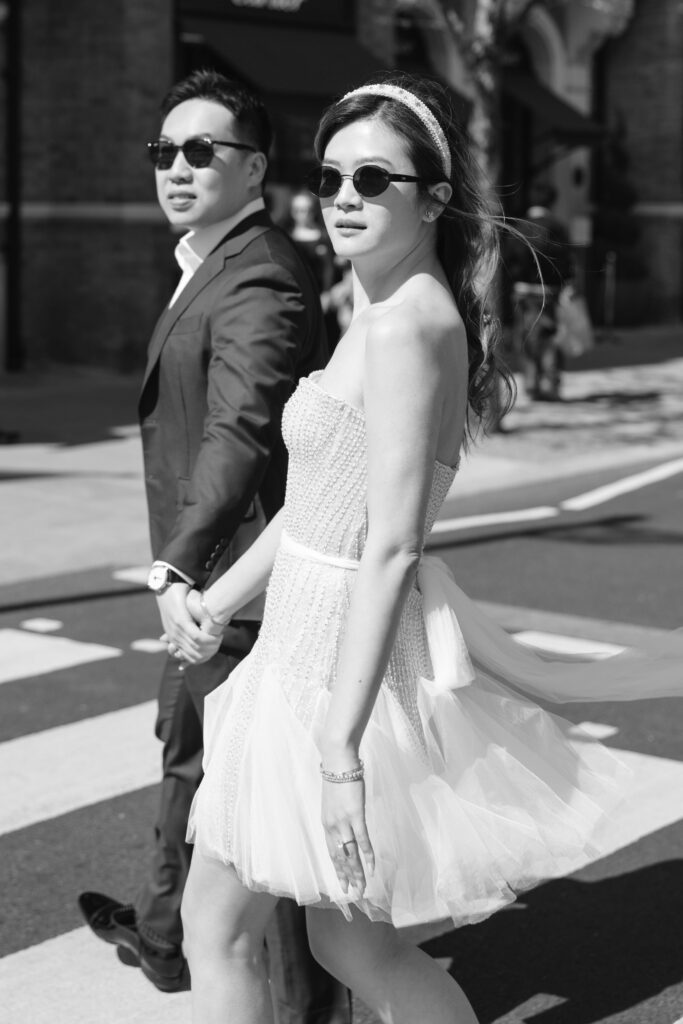 london pre wedding shoot bride and groom walking holding hands infront of london bus
