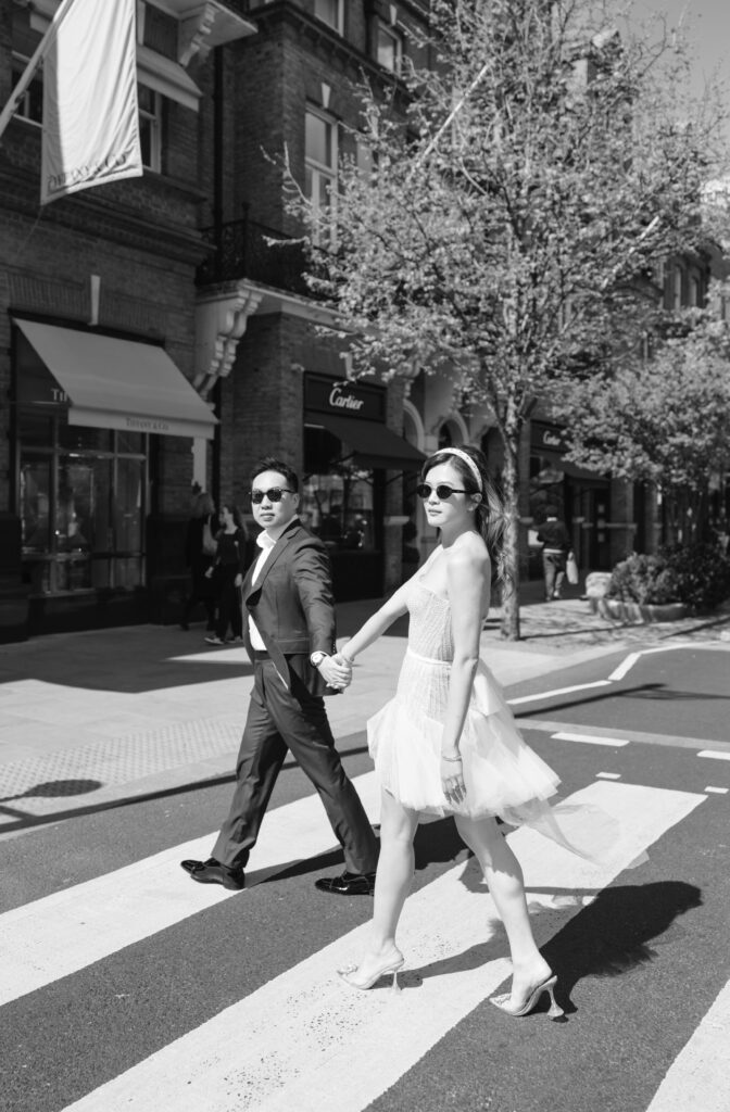 london pre wedding shoot bride and groom walking holding hands infront of london bus
