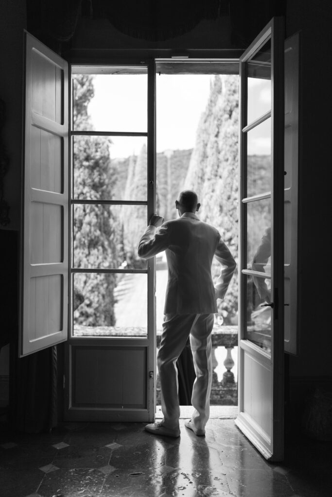 groom looking out of windoe