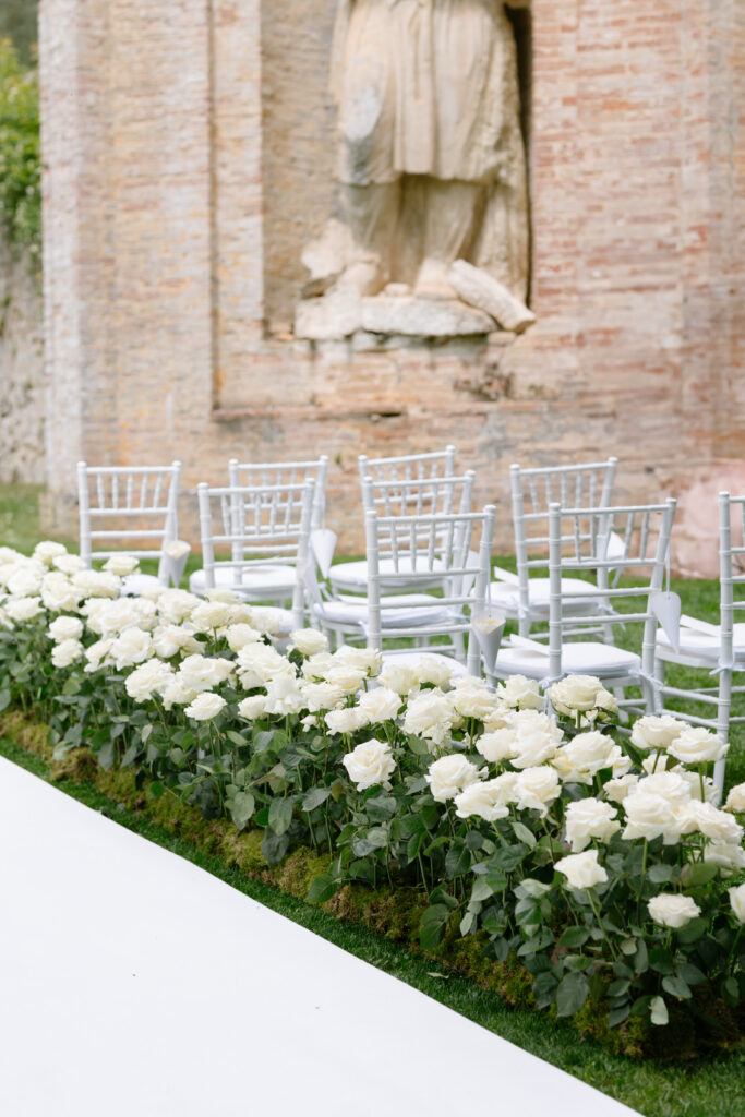 outdoor wedding Villa cetinale, white carpet white roses