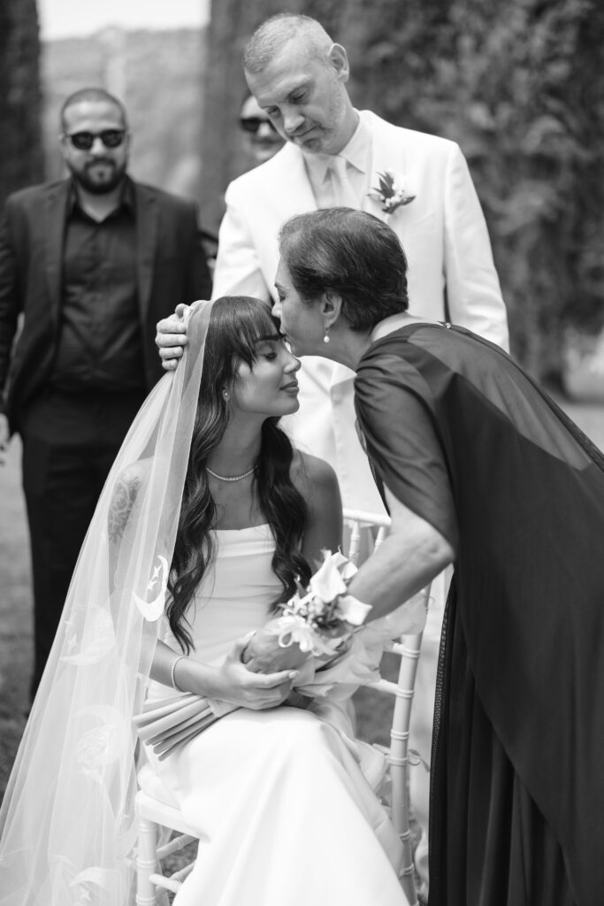 grandmother kissing brides forehead