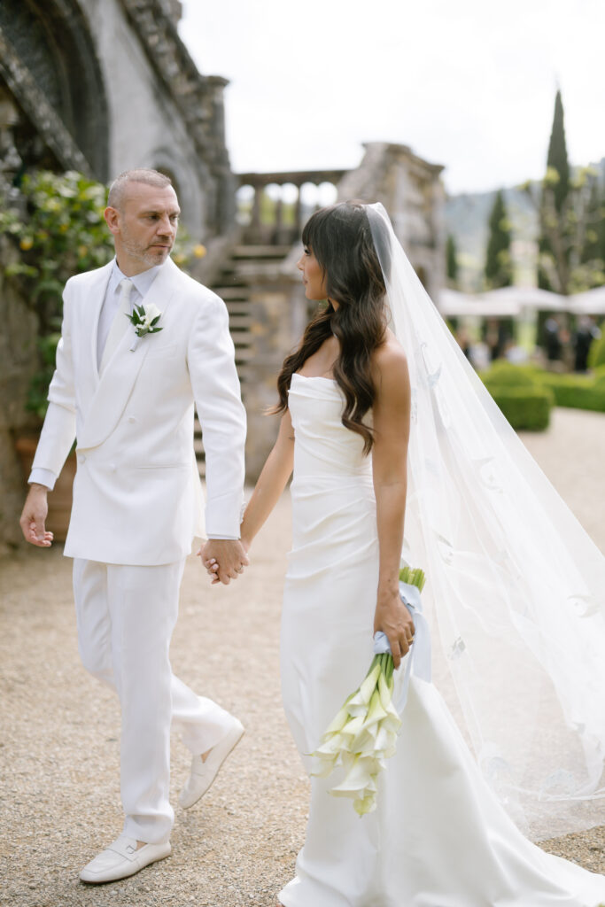 bride and groom walking holding hands