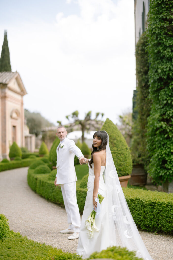 bride and groom walking villa cetinale