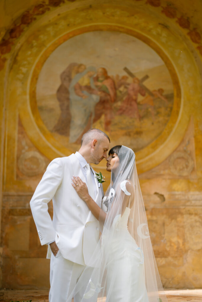 bride and groom infront of votive chapel at Villa Cetinale