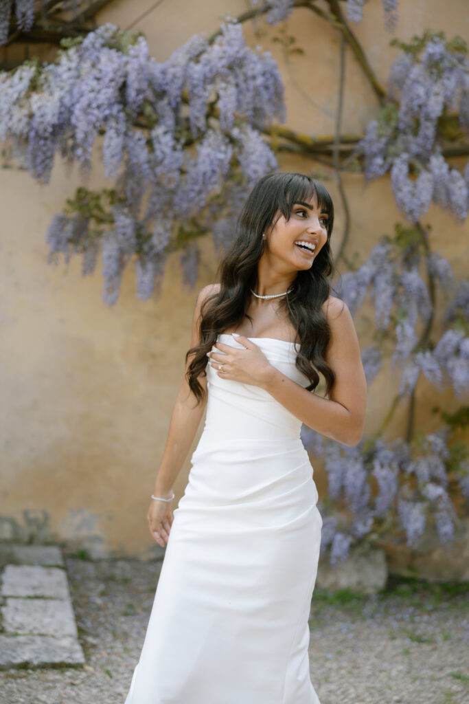bride laughing infront of wisteria