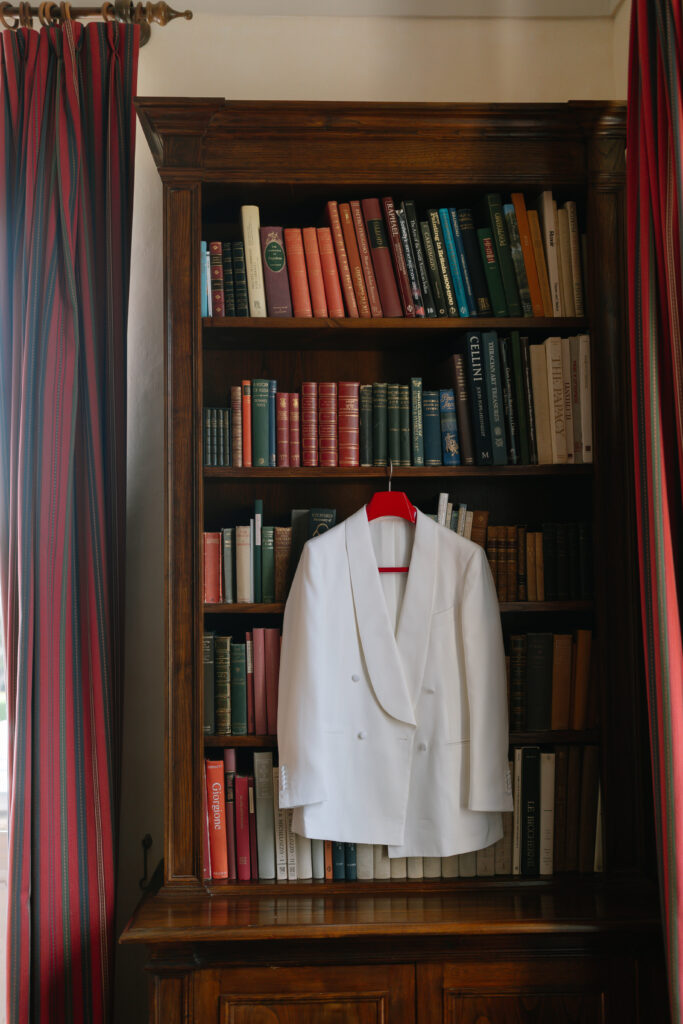 grooms white suit hanging up