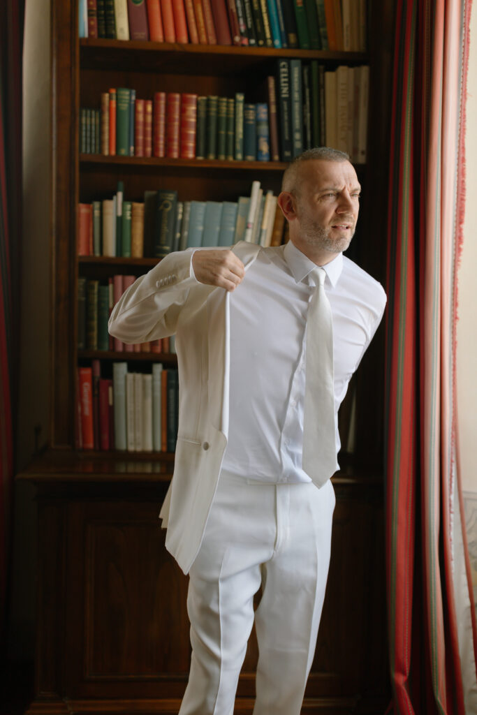 groom getting jacket on