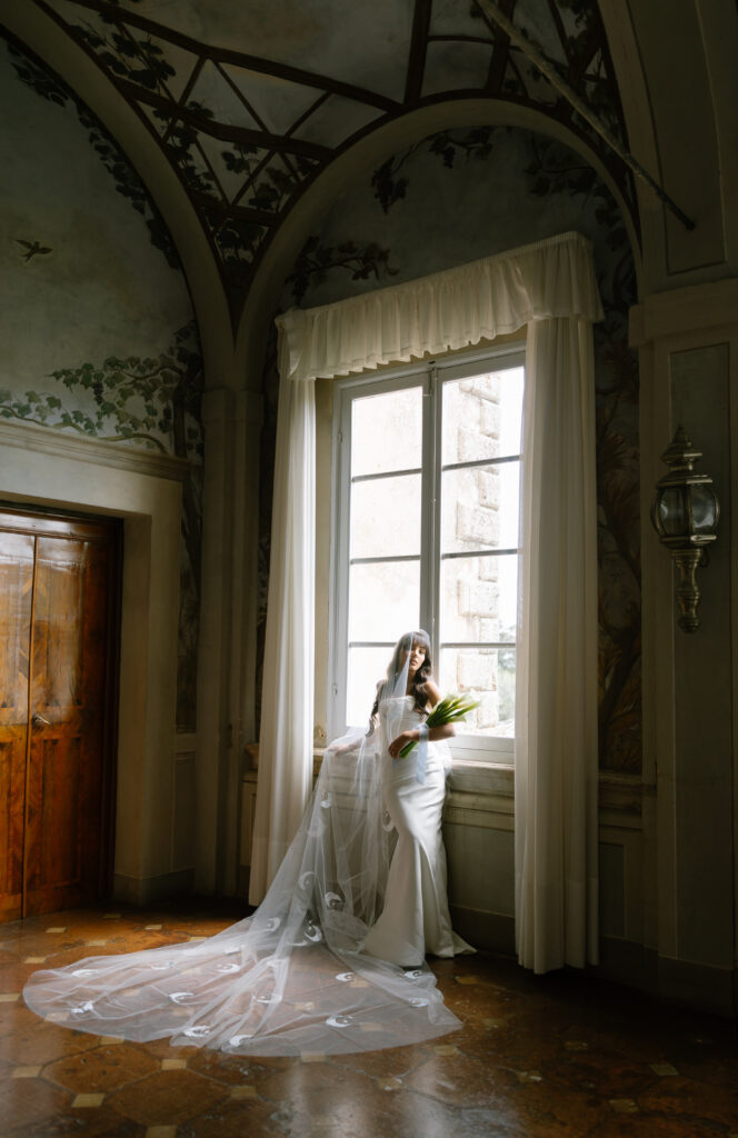 bride standing in front of window