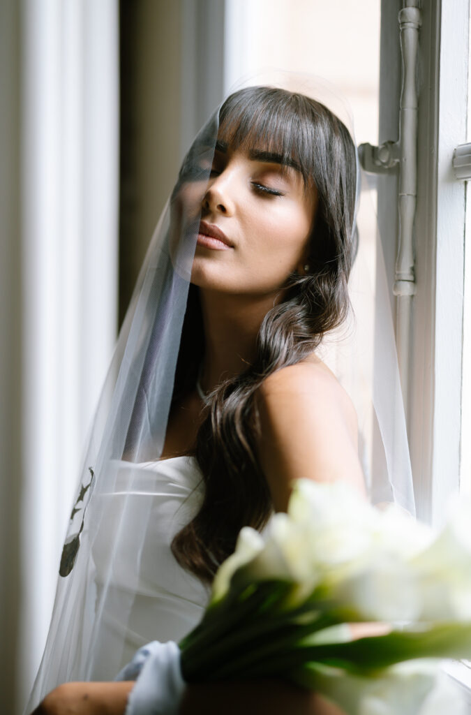 bridal portrait with veil half infront of face