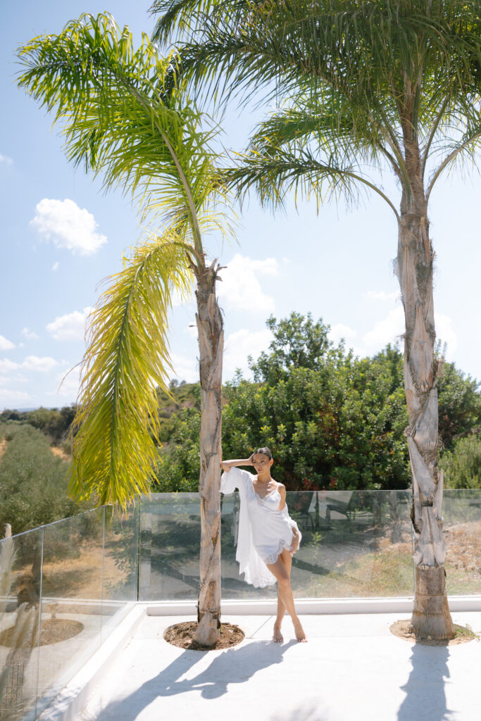A woman in a white dress posing for a picture.