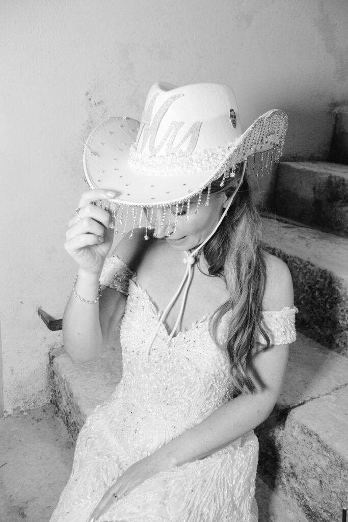 A woman wearing a white dress and hat.